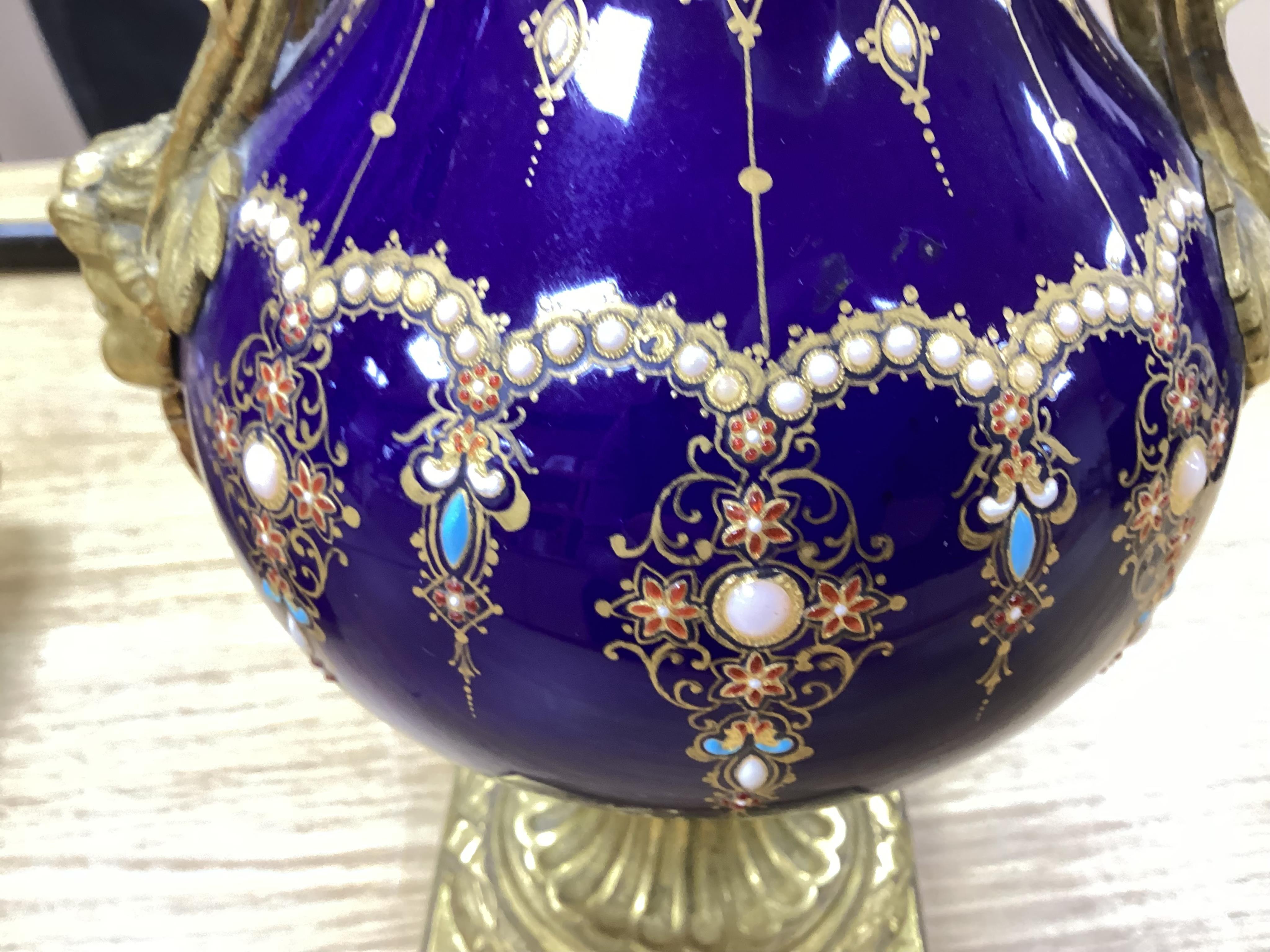 A 19th century Sevres style jewelled porcelain and ormolu matched clock garniture, striking on a bell, with pendulum, 51cm high. Condition - fair to good, minor restoration, untested